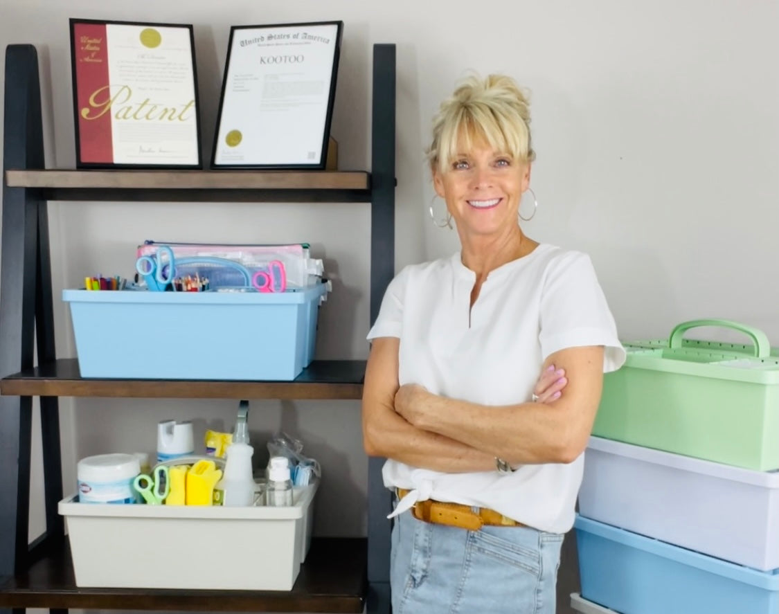 Woman standing in a room with caddies that she has patented. 